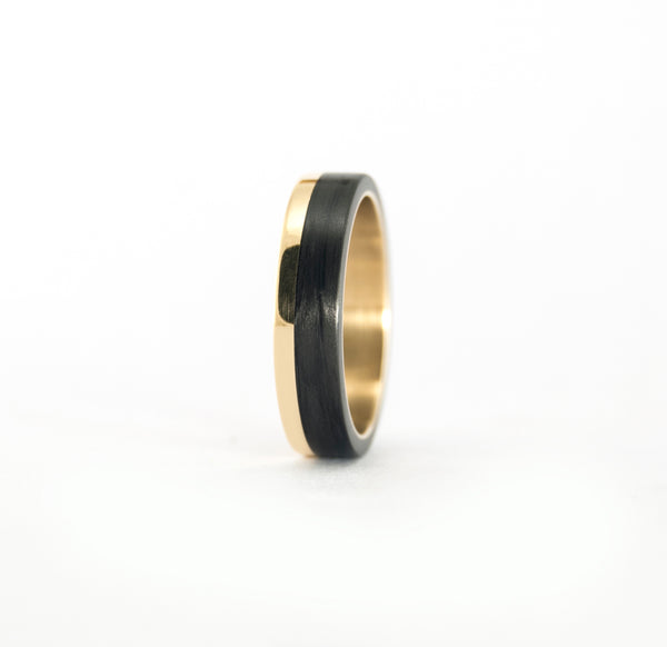 18k Yellow Gold and Carbon Fiber wedding bands.