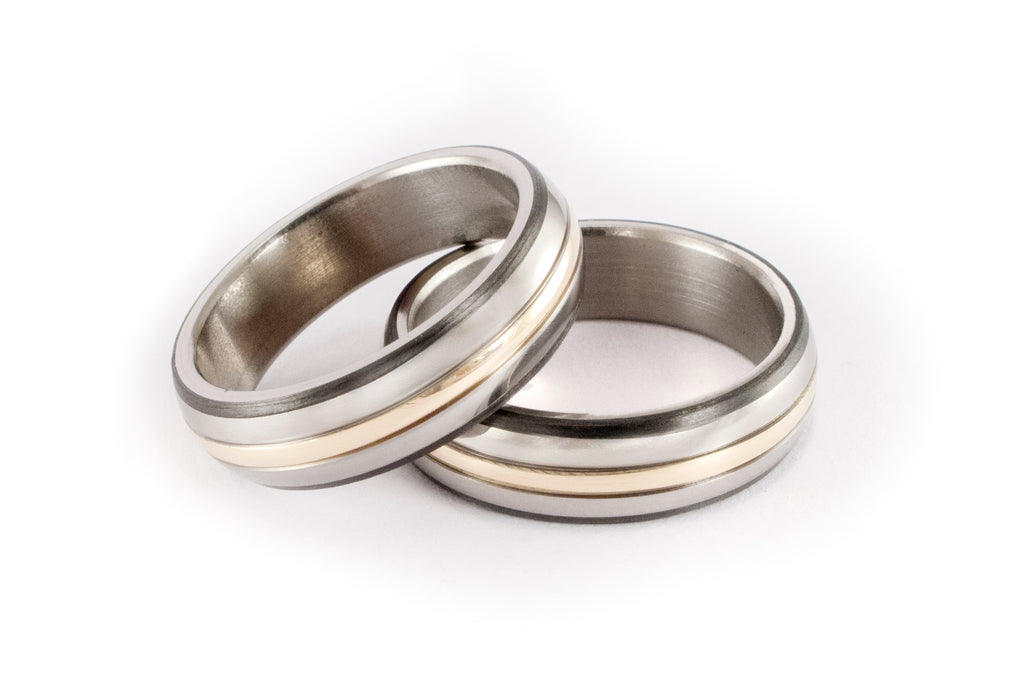 Titanium and yellow 18ct gold wedding rings with carbon fiber band inlays. (04777_7N7N)